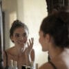 woman_looking_into_mirror_checking_skin