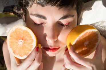 woman holding oranges vitamin c